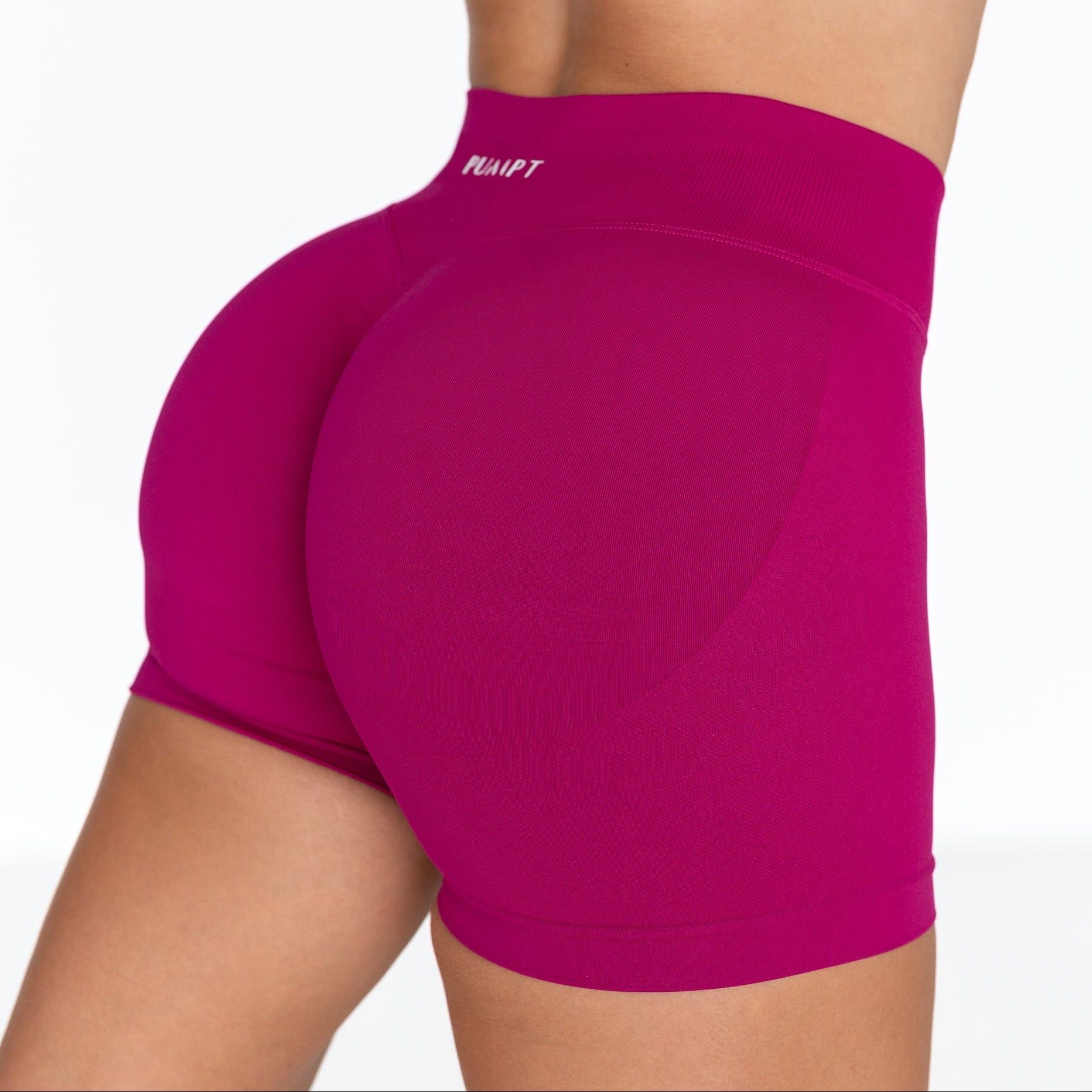 Pink athletic shorts with a brand logo on a white background