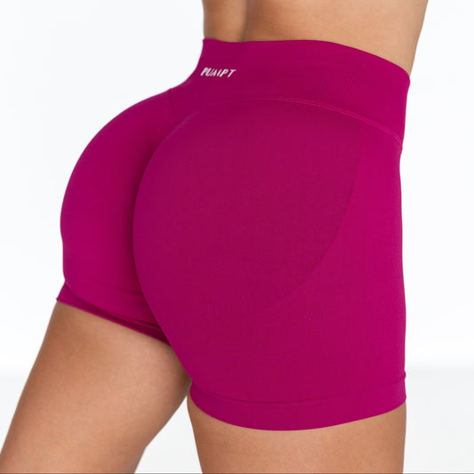 Pink athletic shorts with a brand logo on a white background