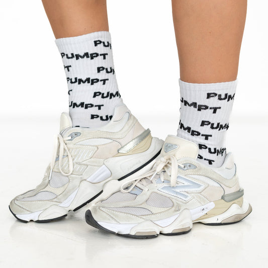 White sneakers with black text and matching socks on a white background