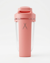 Pink shaker bottle with a clear compartment on a white background