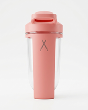 Pink shaker bottle with a clear compartment on a white background