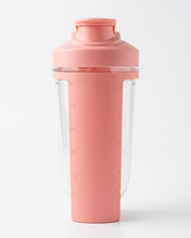 Pink shaker bottle with clear compartment on a white background
