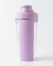 Purple protein shaker bottle with clear compartment on a white background
