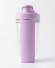 Purple protein shaker bottle with clear compartment on a white background