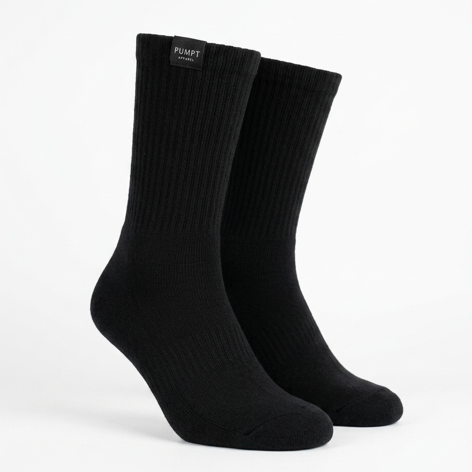 A pair of black ribbed crew socks displayed on invisible forms against a clean white background. The brand name 'PUMPT Apparel' is visible on a small black label at the top cuff.