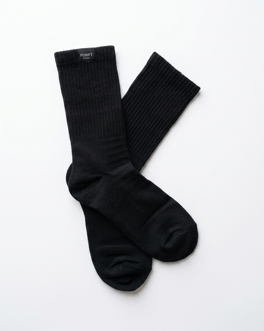 A pair of black ribbed Pumpt Appparel crew socks laid flat on a clean white background.