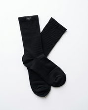 A pair of black ribbed Pumpt Appparel crew socks laid flat on a clean white background.