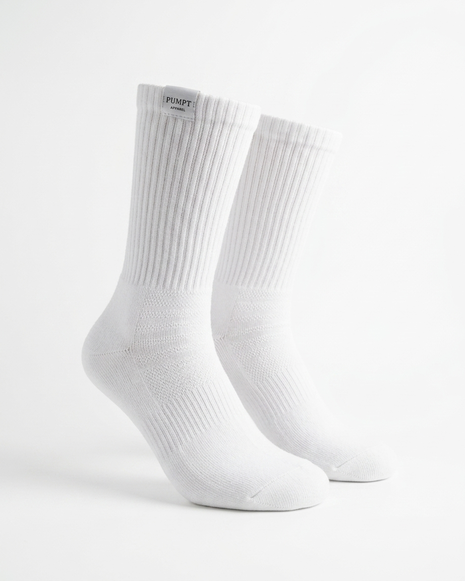 A pair of white ribbed crew socks displayed on invisible forms against a clean white background. The brand name 'PUMPT APPAREL ' is visible on a small black label at the top cuff.