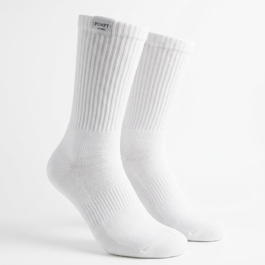 A pair of white ribbed crew socks displayed on invisible forms against a clean white background. The brand name 'PUMPT APPAREL ' is visible on a small black label at the top cuff.