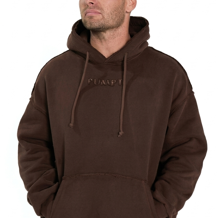 Man wearing a brown hoodie and pants with 'PUMPT' branding on a white background