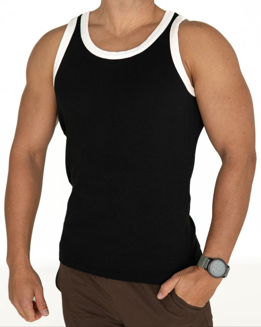 Man wearing a black tank top with white trim on a white background