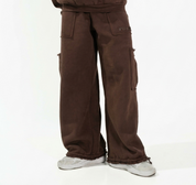 Man wearing a brown tracksuit on a white background