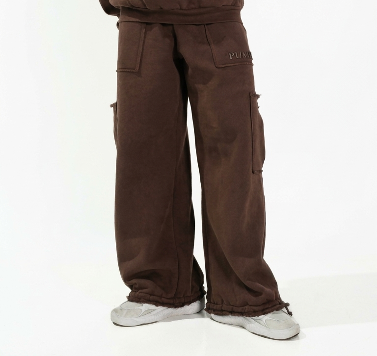 Man wearing a brown tracksuit on a white background